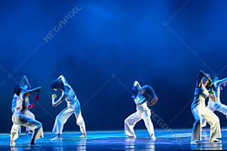 Expressive Contemporary Dancers Performing Under Blue Stage Lighting