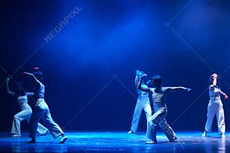 Wide Contemporary Dance Performance Under Blue Theater Lights