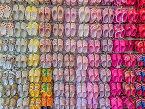 Hawaii, USA - 4.20.2025: Brightly colored Croc shoes displayed on the wall at Crocs in Ala Moana Shopping Center during