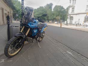 Poland Krakow May 24, 2026 2:15 PM. Yamaha Ténéré 700 Rally - blue motocross bike parked in the city