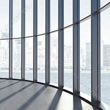 Round interior with large windows and sunlight.