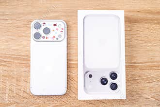 Bar, Montenegro: February 6, 2026: Overhead view of white apple iphone 17 pro with stickers beside open product box on