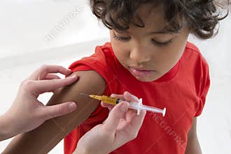 Boy receiving vaccine in the arm
