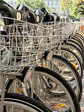 Bicycles for rent with basket parked in a row in the city of Valencia, Spain
