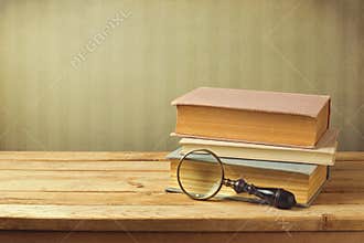 Old books with vintage magnifying glass