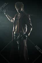 Brutal man with a sword isolated on black