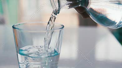 Pouring glass of water