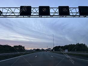 Dusk View of Busy Multilane Highway Stretch Leading Toward City Center with