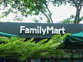 FamilyMart convenience store exterior signage framed by green trees
