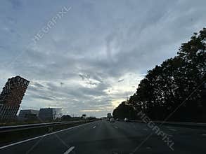 Driving on A10 Ring Road at Golden Hour Through Amsterdam Zuidas Business