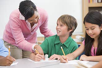 Teacher and pupil in elementary school classroom