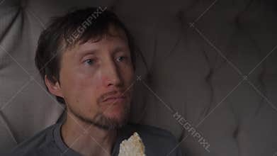 Middle aged man eating and crunching a rice cracker, high quality uncompressed audio recording. Crisp chewing sounds and