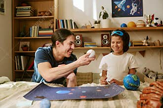 Father and Son Learning About Space and Science at Home