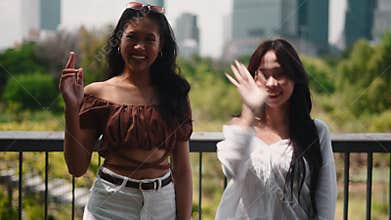 Young asian influencers creating social media video content outdoors