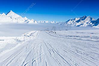 Ski slope in the mountains. Sunny winter landscape