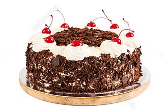Black forest cake decorated with whipped cream and cherries