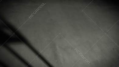 Prison cell door closing shadow on dark concrete jail floor.