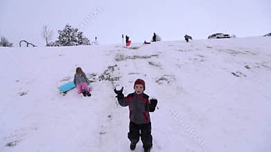 Boy throwing snowballs at camera