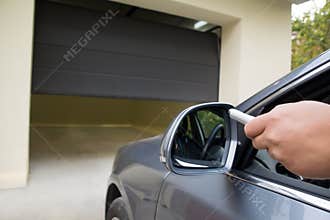 Driver opens the garage with remote control