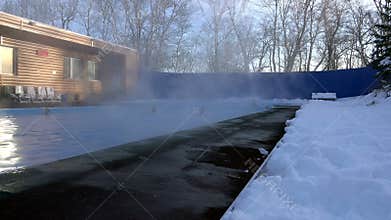 People on a sunny winter day improve health in the living springs of thermal waters