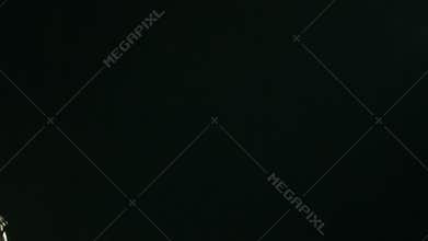 Cool looking guy dancing in the beam of light on a black background
