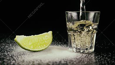 Pour tequila in a shot. Slow motion