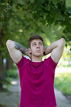 Male teenager tattooed arm in park