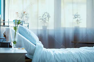 Empty hospital bed in clinic chamber