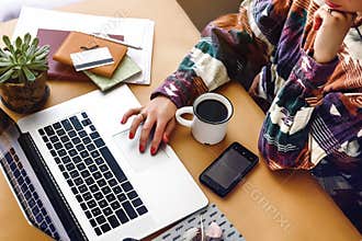 stylish girl hipster hands on laptop searching and typing, freelance and planning boho summer travel vacation concept