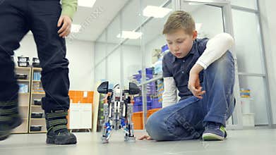 School boys making self-made elephant robots at engineering school lab.