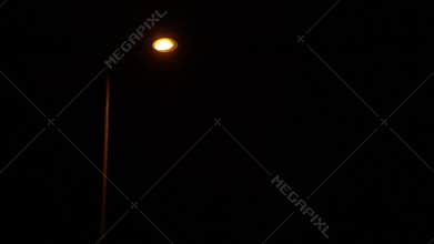The street lamp turns on and off