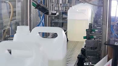 Industrial machine tightening the Bottle Caps on plastic Bottles on the Conveyor. 4K.