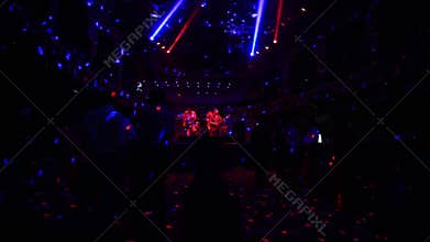 A party in a nightclub. Dancing crowd. Light and glare of search