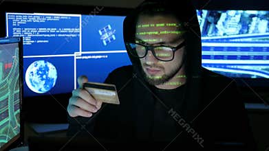 Computer terrorism, steal finances through the internet, criminal hacker cracking banking system, hacker holds in hands
