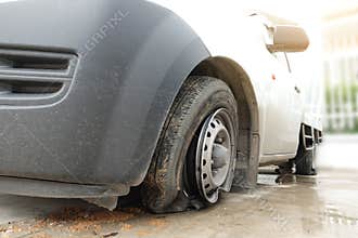 Damage on tire of white car