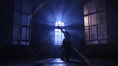 Hip-hop performed slim dancer girl. Silhouette in moonlight, slow motion