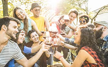 Group of friends toasting wine having fun at barbecue garden party