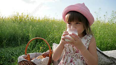 Healthy kid drinks milk from glass, sweet girl beverage from dairy products, Pleasure on child`s face, milk advertising