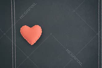Red heart on black book. love backdrop