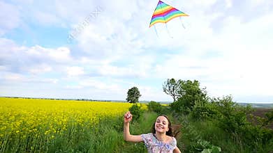 A child runs through a meadow with a kite