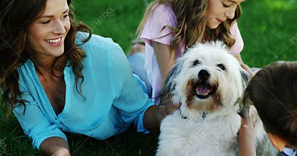 Family playing with their dog in the park