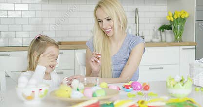 Laughing family coloring eggs