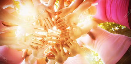 Smiling women organising event for breast cancer awareness