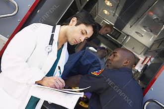Hospital doctor taking notes paramedics