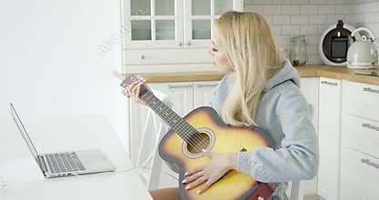 Woman playing electric guitar