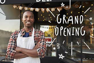Black male business owner outside coffee shop grand opening