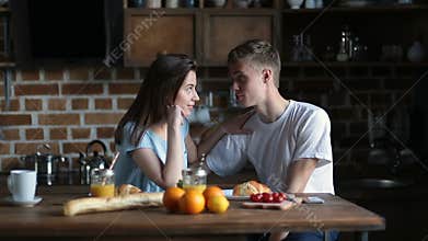 Cute couple having breakfast together at home