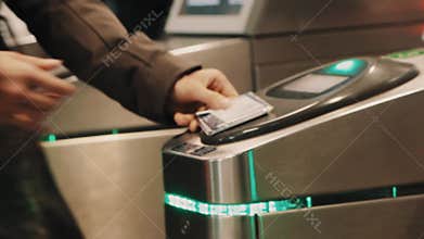 Rush hour metro wicket control panel, people paying for enter with cards