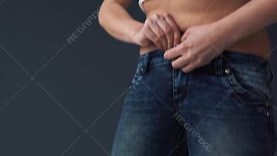 Fat woman body trying to put on her tight jeans