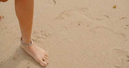 Bare Feet Coated in Sand Walking on Beach